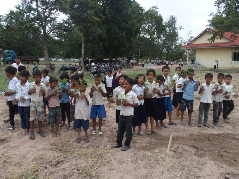 Cambodian schoolchildren planting trees on their school
