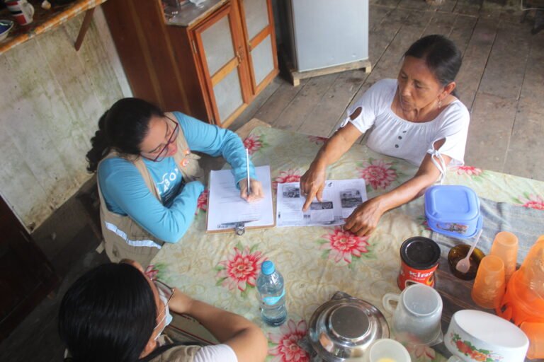 Indigenous woman sharing information with GGF technical collaborators (forest custodians) about wildlife sightings in the locality