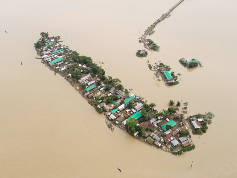 Ariel view of small flooded island with buildings.