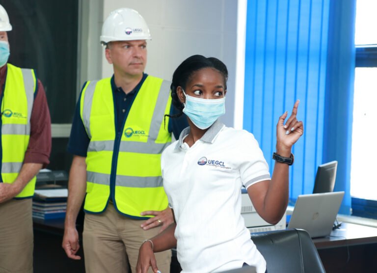 U.S. Experts and a UEGCL Employee at the Isimba Hydropower Plant as part of U.S. Energy Association's Energy Utility Partnership Executive Exchange in May 2022