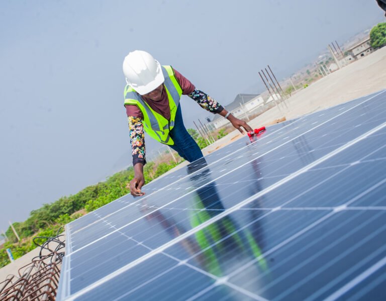 A female engineer installing a solar panel