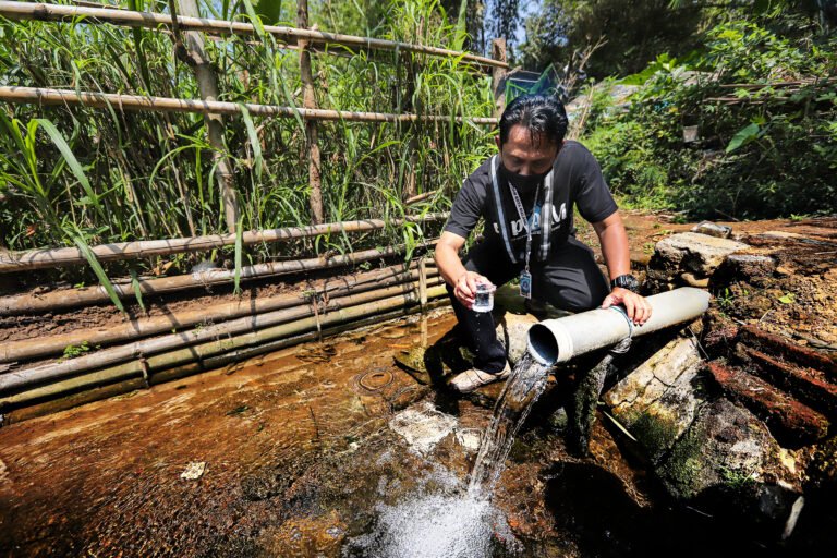 A staff of the drinking water company of Malang city is testing water quality