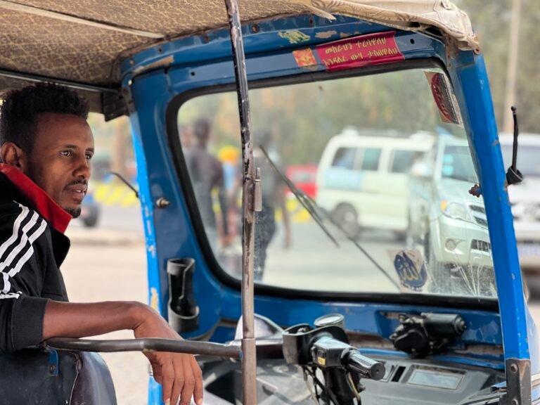 A bajaj driver looks for his next customer