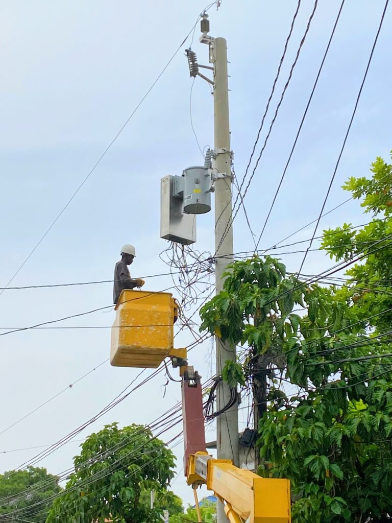 A man fixing the electricity in Steer Town, Jamaica.