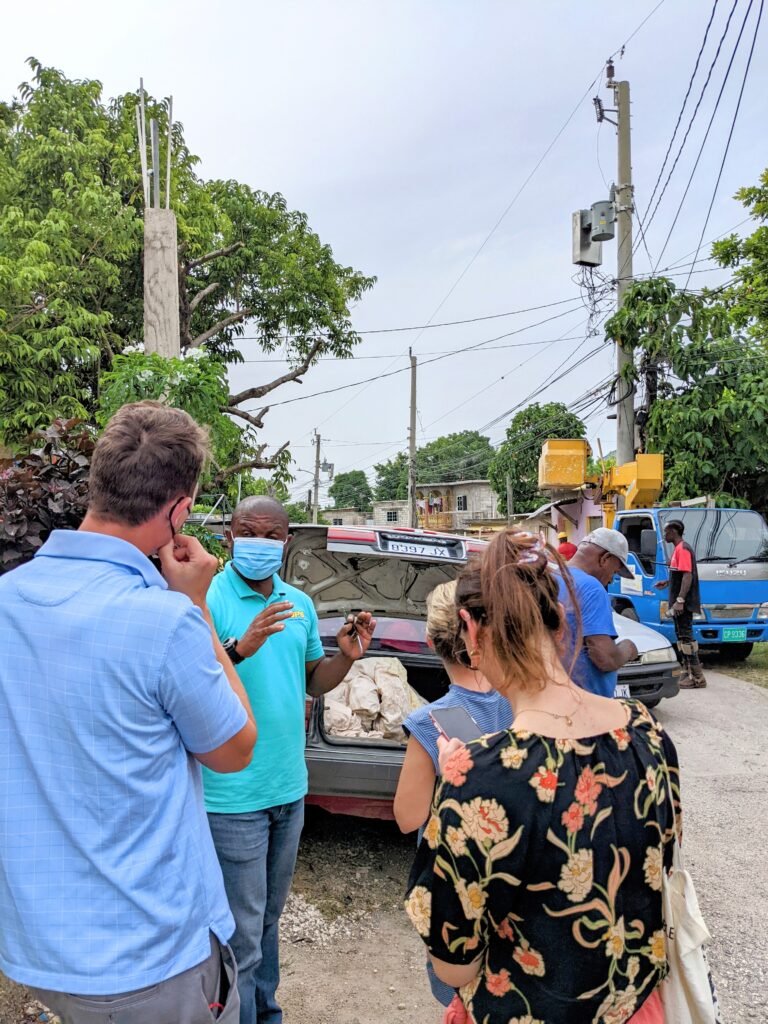A group of locals chatting during the site visit in Steer Town, Jamaica.