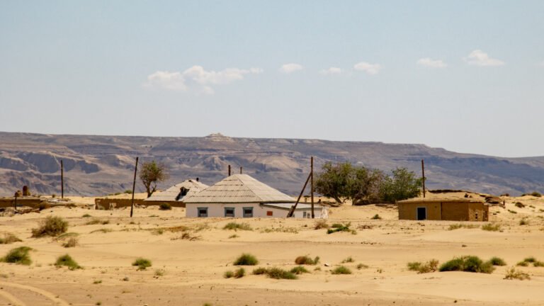 several small huts on arid landscape