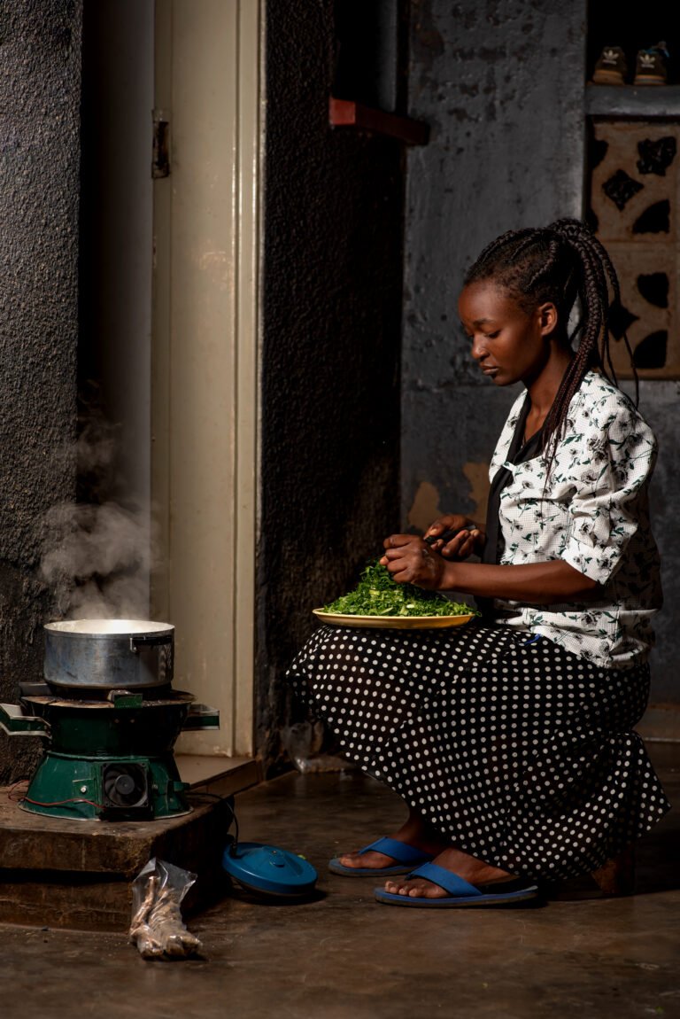 Photo of an individual using an improved cookstove in Malawi