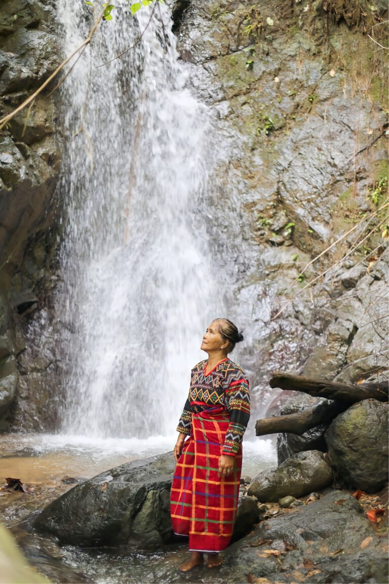A Tboli woman coffee farmer looks up to the waterfalls