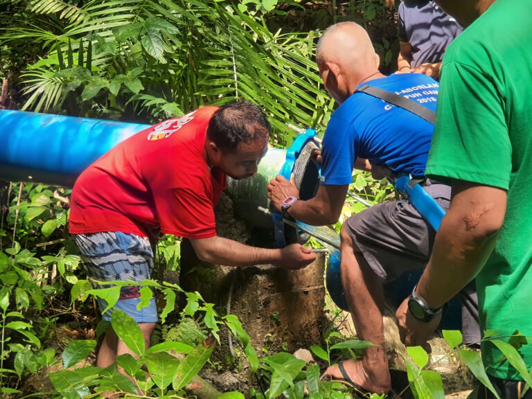 Water workers repairing a pipe within the watershed