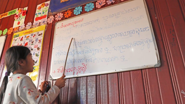 Chanthy Sari, a young indigenous Bunong student, is reading out aloud to other students in the Jahoo Conservation Club
