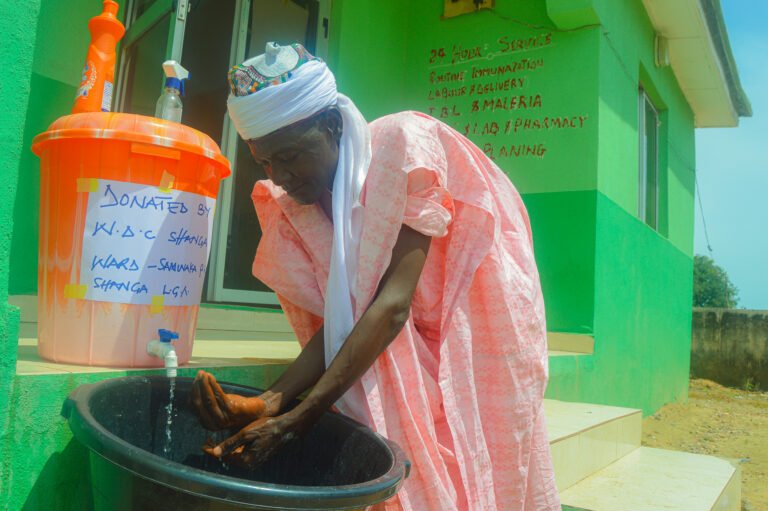 Using a Locally Made Hand Washing Station at a Health Facility.jpg