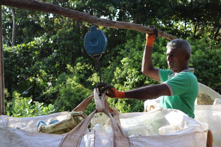 Man Weighing Collected Plastics: Dickwella, Sri Lanka, July 2023