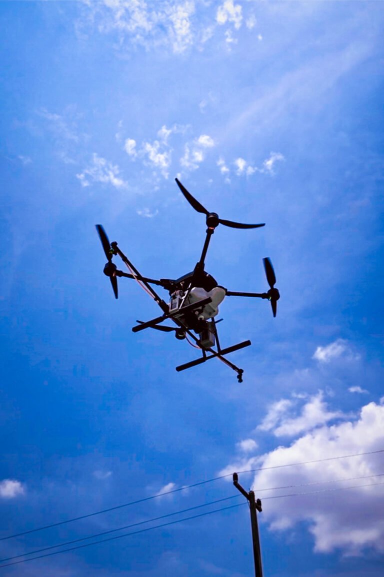 View of drone in a blue sky from below.