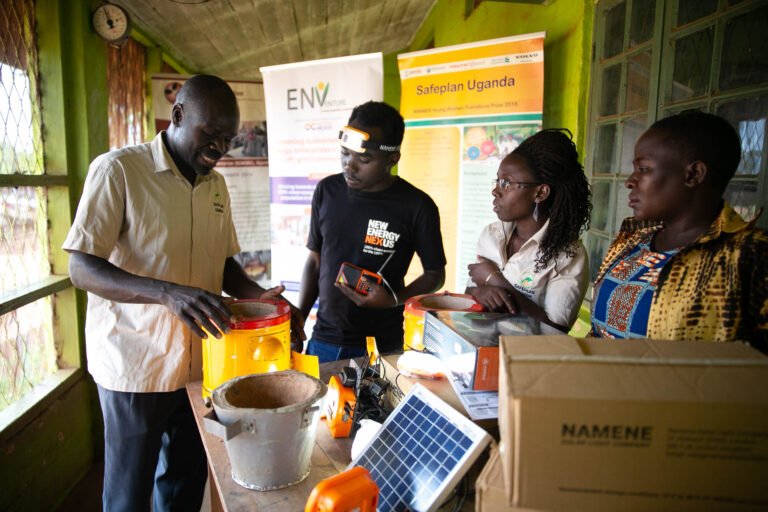 Three people watching a project officer during a coaching session.