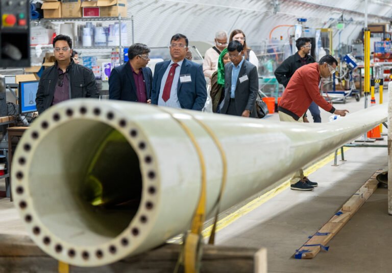 Partners from Bangladesh examining and learning about wind turbines.
