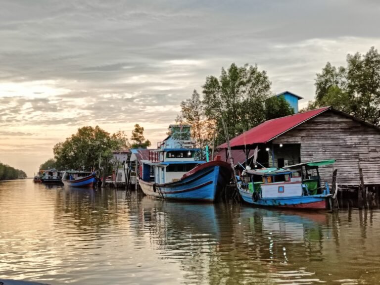 Boats and buildings in a small fishing community on a cloudy day.