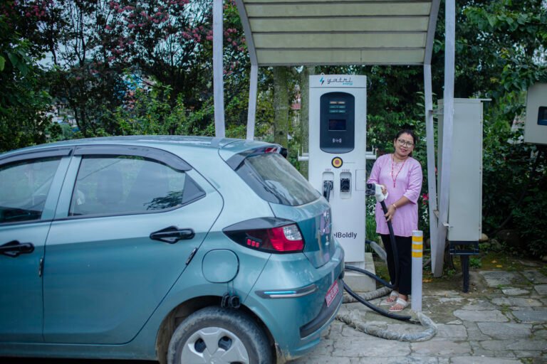 EV owner charges her car.