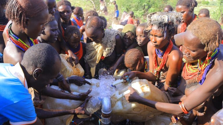 Community members in Mermerti, South Omo zone, Ethiopia, fill containers with clean water at a newly activated water supply point (expected to benefit for over 6,000 households), part of USAID’s CR WASH Activity aimed at improving access to fresh water.