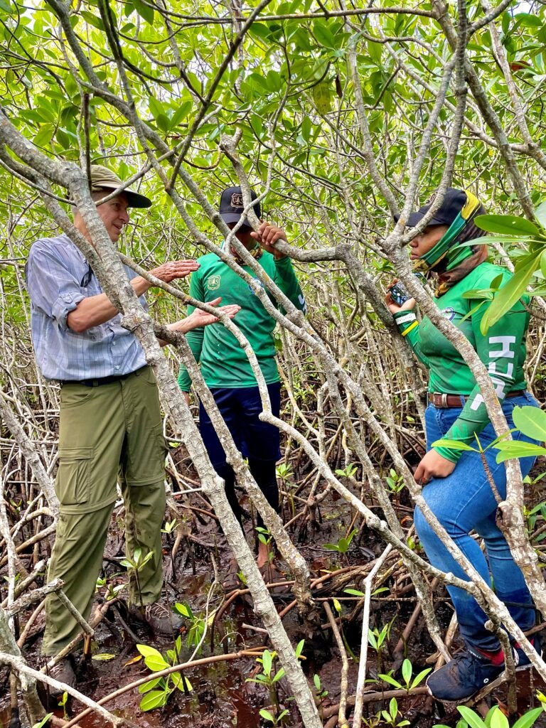 Two youth learning about mangrove measurements from a US FS scientist Dr. Carl Trettin