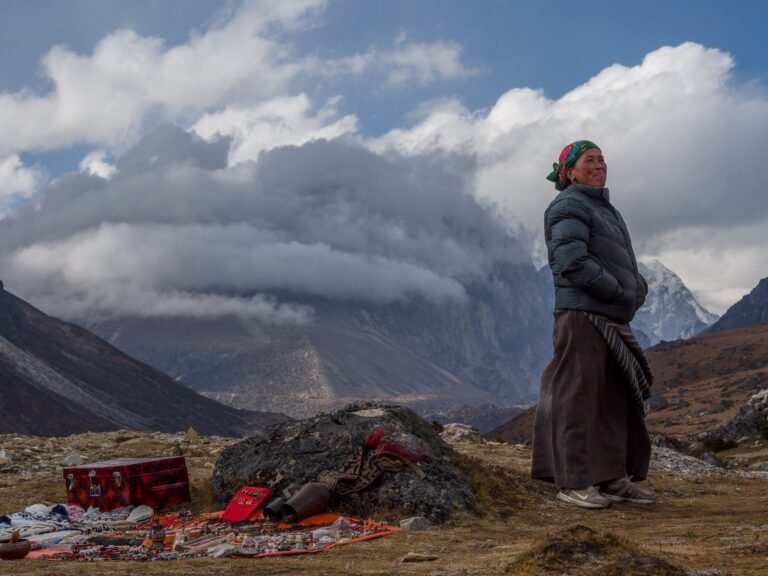 A woman sets up shop with her wares at more than 14,000 feet in the Nepalese Himalaya, near Lungden