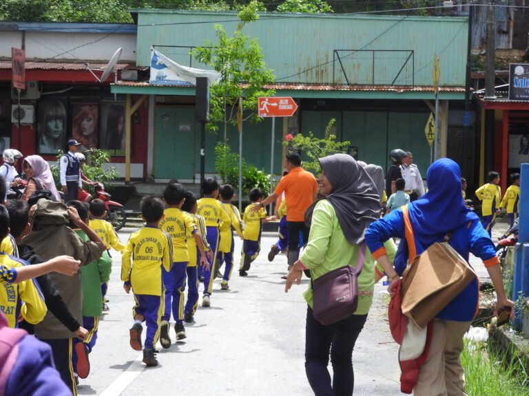 Children line up outside of a school after a disaster evacuation drill.